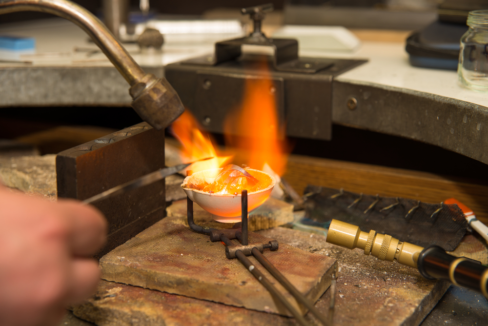 Jeweler melting gold in crucible with gasoline burner - Image(badahos)s
