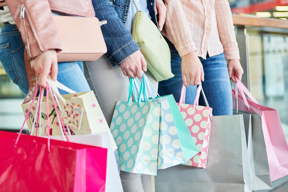 Three women with many shopping bags as a symbol of consumption and purchasing power - Image( Robert Kneschke)s