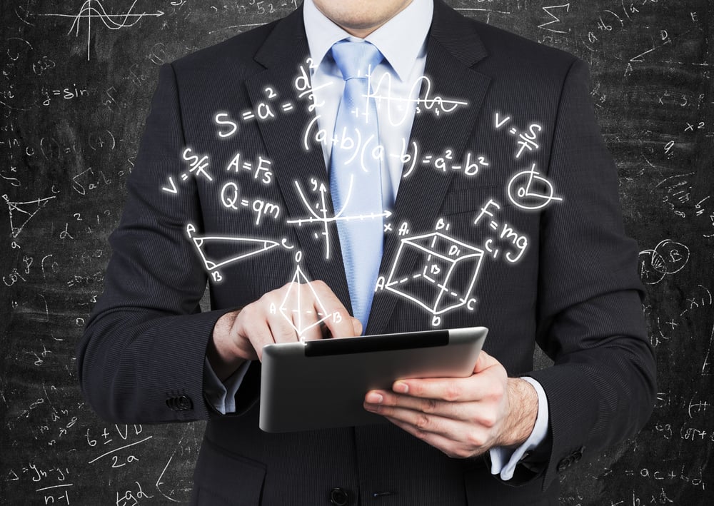 Young man in formal suit is holding a tablet with math formulas projection on the air. - Image(ImageFlow)s