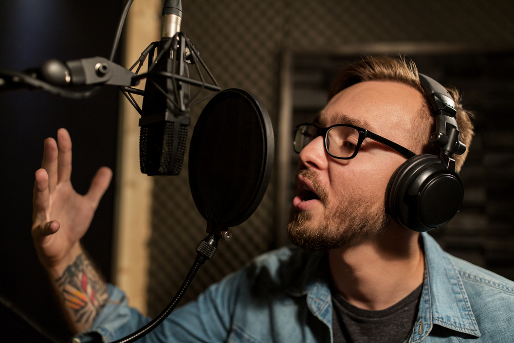 music, show business, people and voice concept( Syda Productions)s