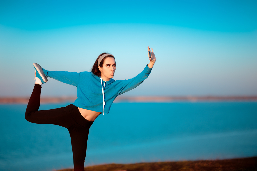 Girl in Yoga Pose Taking a Selfie Outside in Nature( Nicoleta Ionescu)s