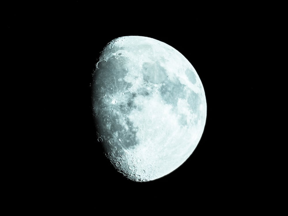 Waxing gibbous moon over dark sky at night( Claudio Divizia)S
