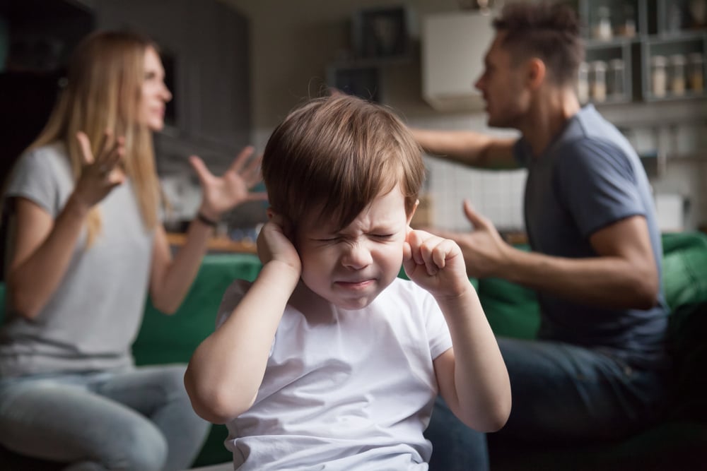 Frustrated kid son puts fingers in ears not listening to noisy parents arguing(fizkes)s