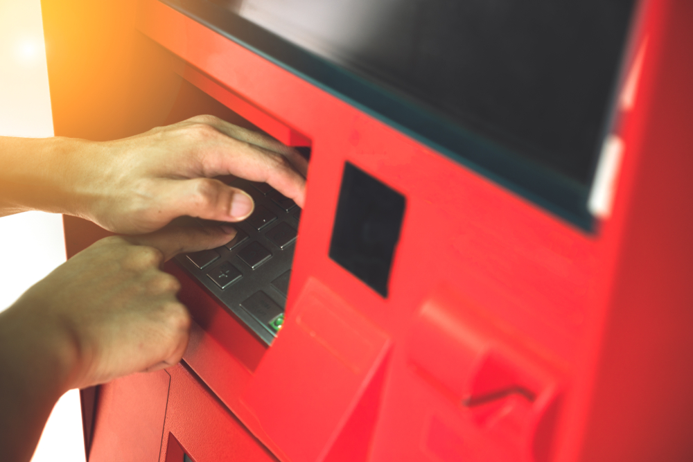Close up man hand entering PINpass code on ATM machine(AePatt Journey)s