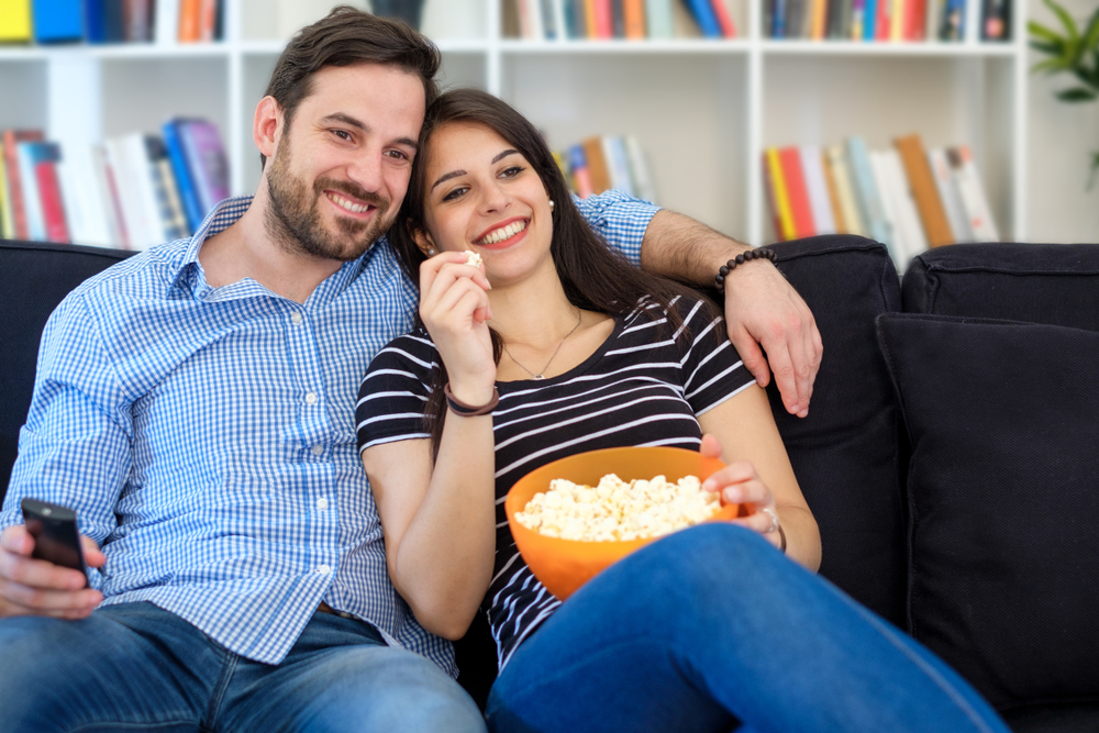 Young couple watching tv at home and having fun(tommaso79)s