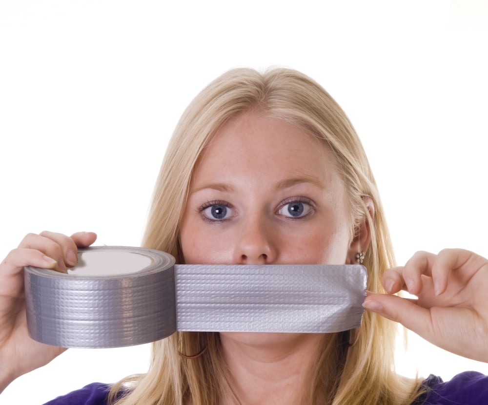 Blonde woman tapes her mouth with duct tape(Patricia Hofmeester)s