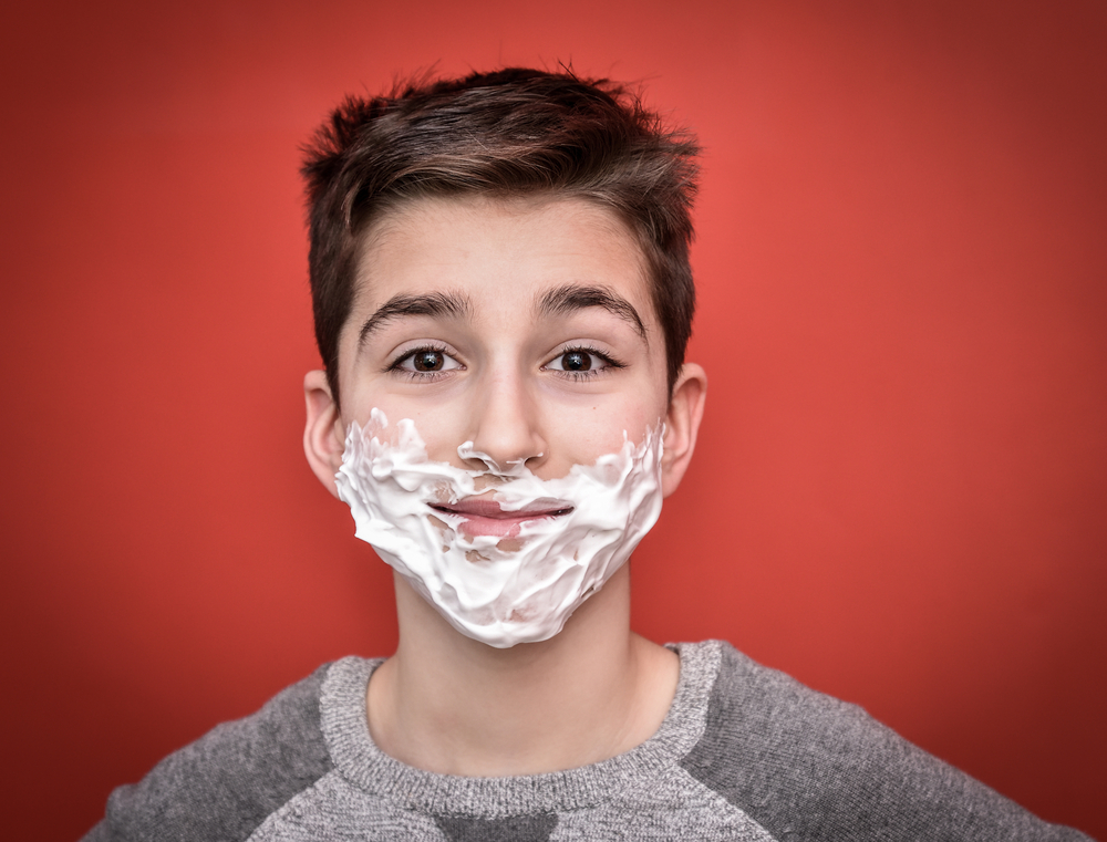 Smiling young boy with shaving foam on his face(Zdravinjo)s