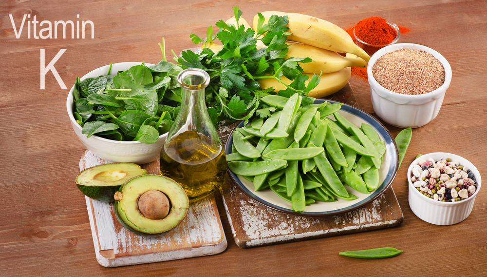 Foods highest in Vitamin K on a wooden board(Tatjana Baibakova)s