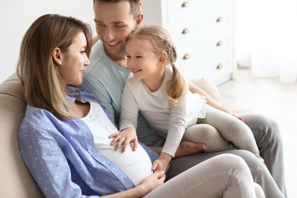 Young pregnant woman with her family at home(New Africa)s