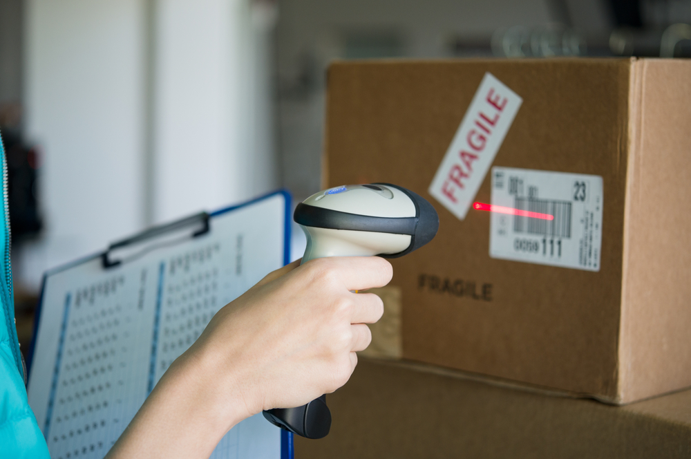 Closeup shot of worker scanning box with barcode reader(Rido)s