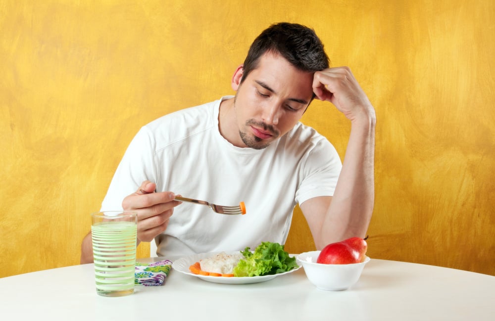 attractive young man not so happy about eating healthy food(Dragana Djorovic)S