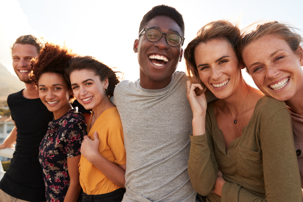 Portrait Of Smiling Young Friends Walking Outdoors Together(Monkey Business Images)s