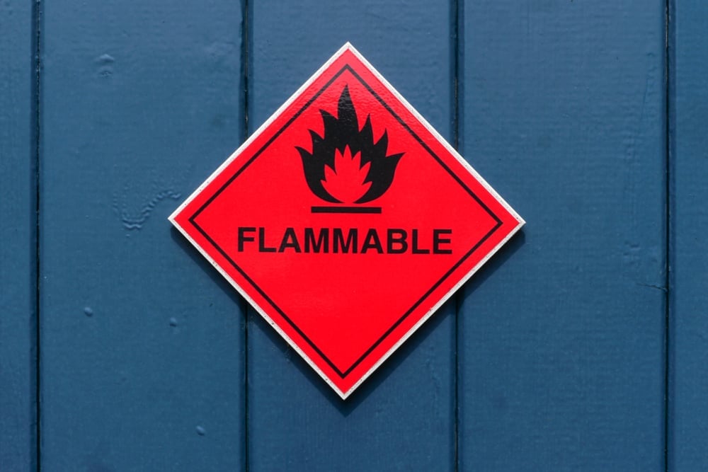 Red diamond shape flammable warning sign on red door(larry mcguirk)S