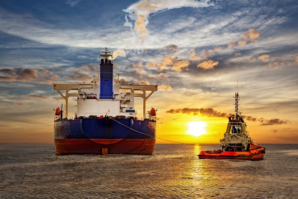 Tanker,And,Tugboat,On,Sea,At,Sunset.