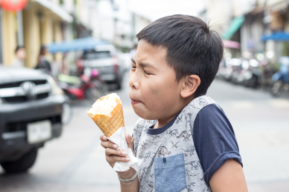 An,Asian,Boy,Experiences,Brain,Freeze,Due,To,Ice,Cream