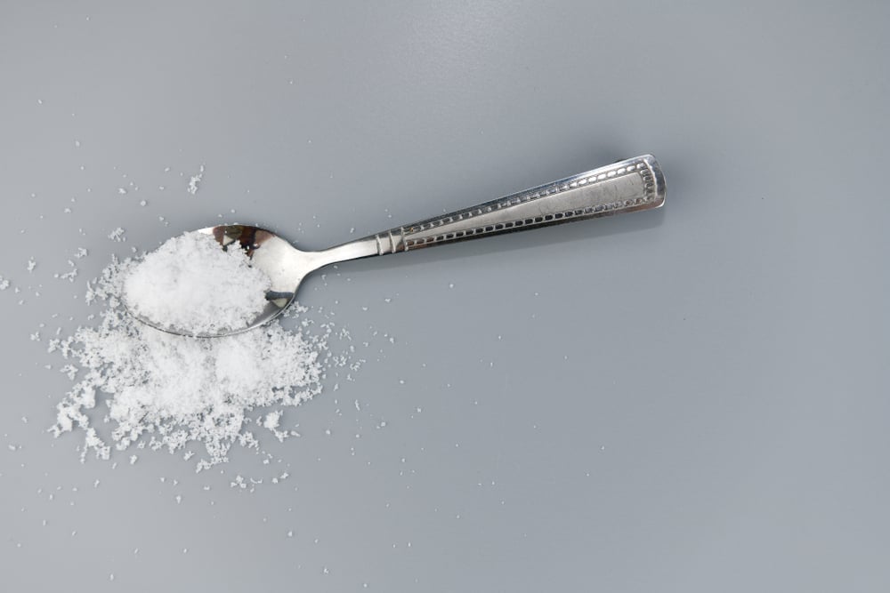 Silver,Spoon,With,Salt,On,Gray,Background.
