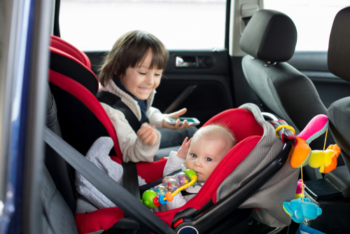 Little,Baby,Boy,And,His,Older,Brother,,Traveling,In,Car