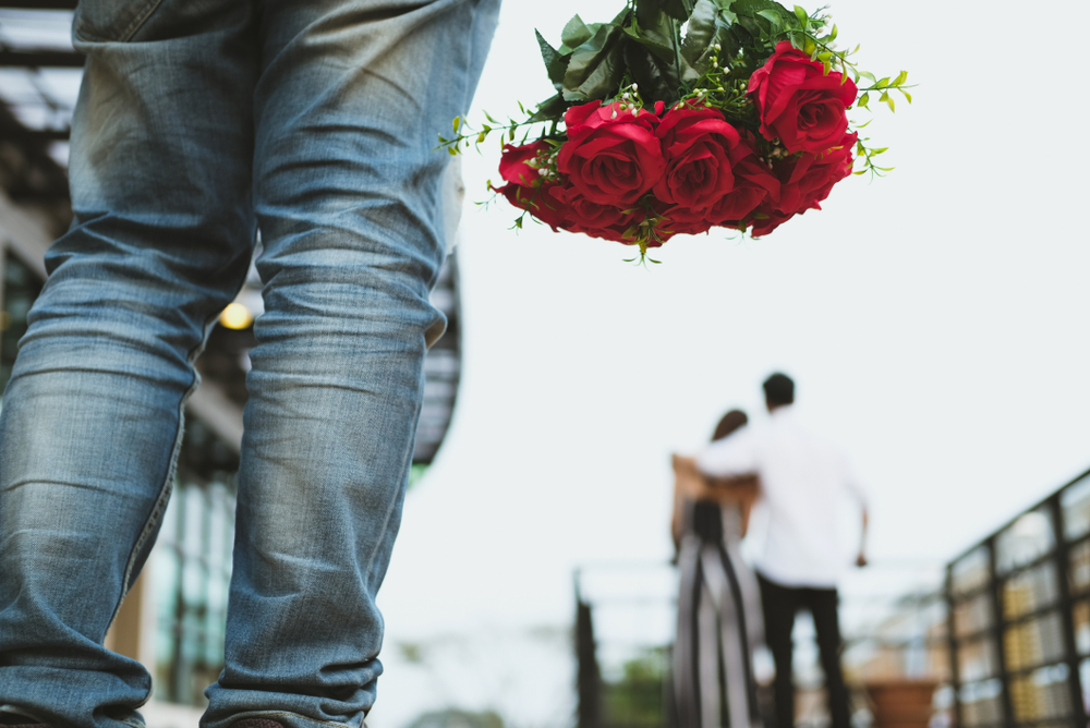 Asian,Heartbroken,Man,Holding,Bouquet,Of,Red,Roses,Feeling,Sad