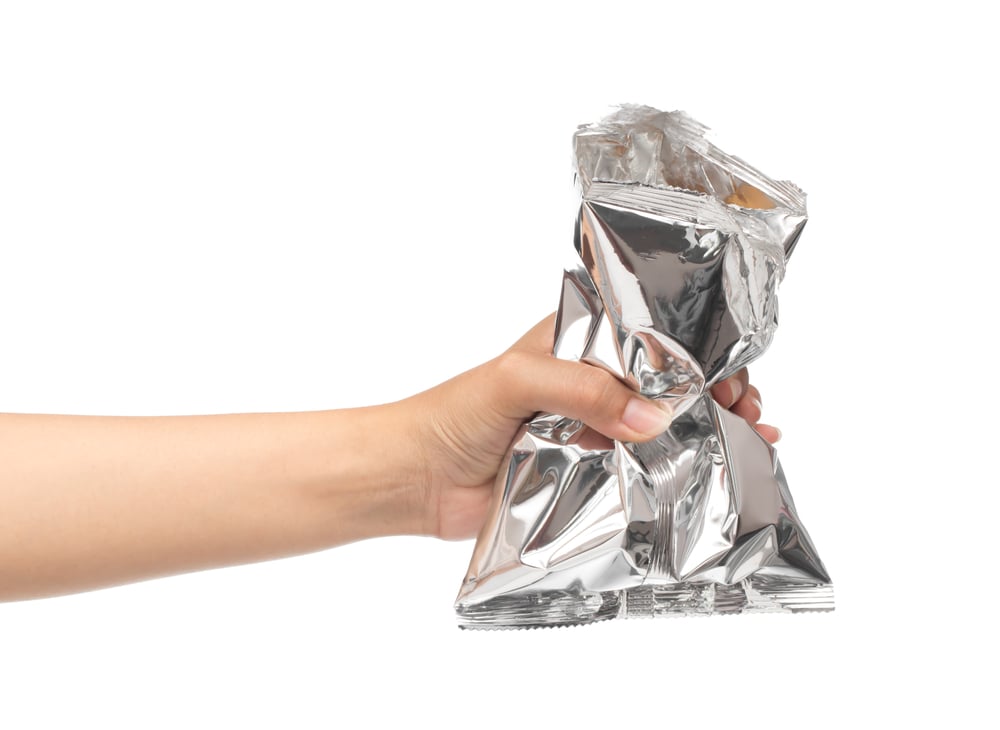 Hand,Holding,Plastic,Bag,Snack,Packaging,Isolated,On,White,Background