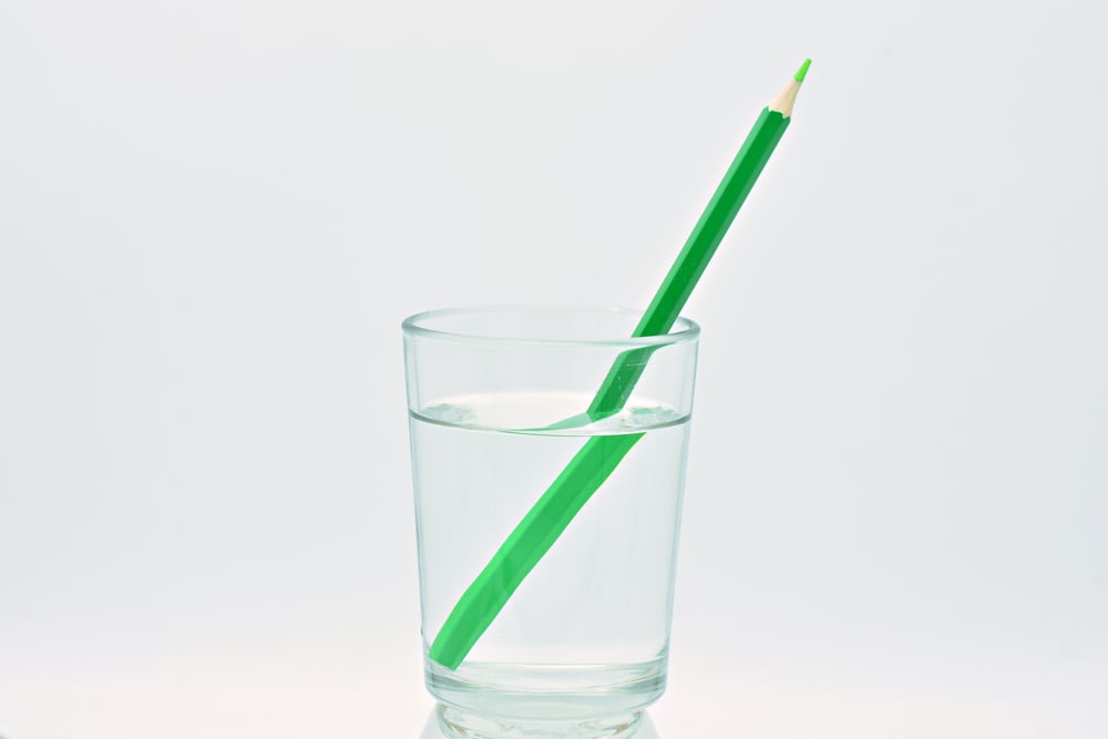 Green,Colored,Pencil,Inside,A,Glass,Of,Water,,Light,Refraction