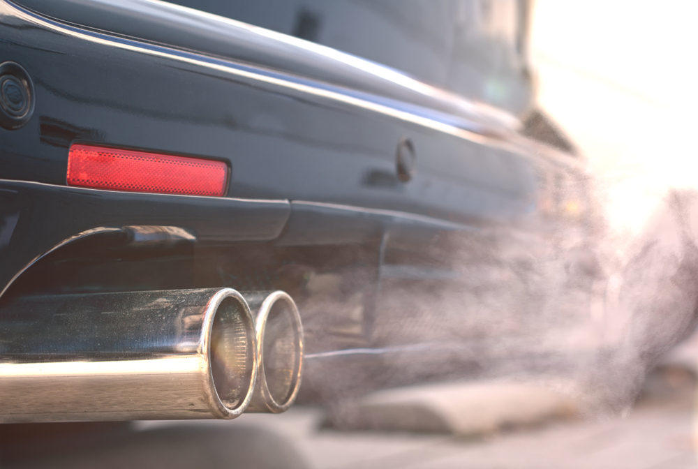 Close,Up,Of,Smoky,Dual,Exhaust,Pipes,From,A,Starting