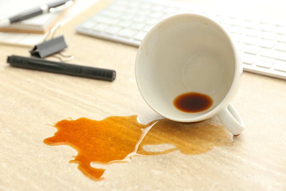 Overturned,Cup,Of,Coffee,On,Office,Table