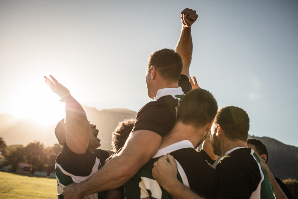 Rugby,Players,Lifting,The,Teammate,After,Winning,The,Game.,Rugby