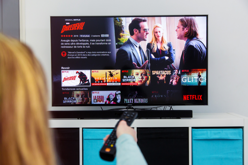 Benon,,France,-,January,21,,2018:,Woman,Holding,A,Tv