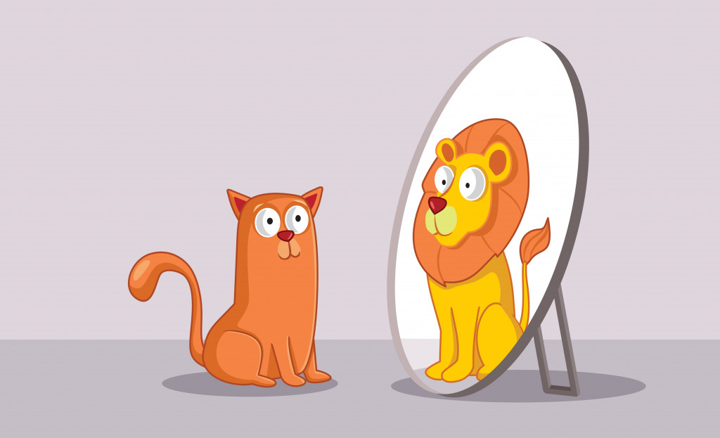 Un chat confiant regarde dans le miroir et voit un lion