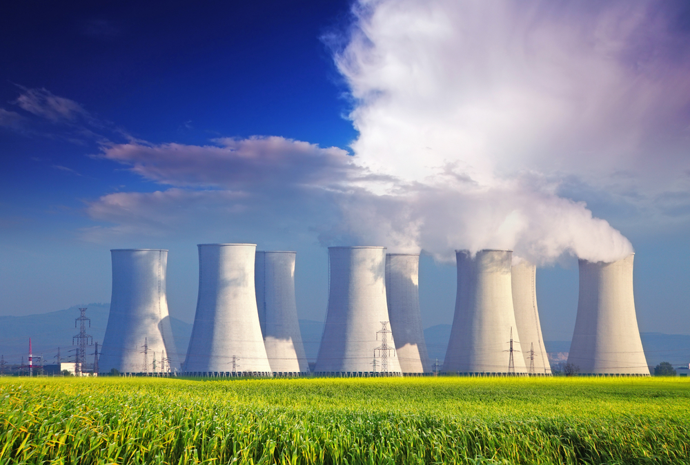 Nuclear,Power,Plant,With,Yellow,Field,And,Big,Blue,Clouds