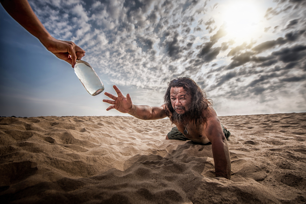 Thirsty,Man,In,Desert,Try,To,Catch,Water,Bottle