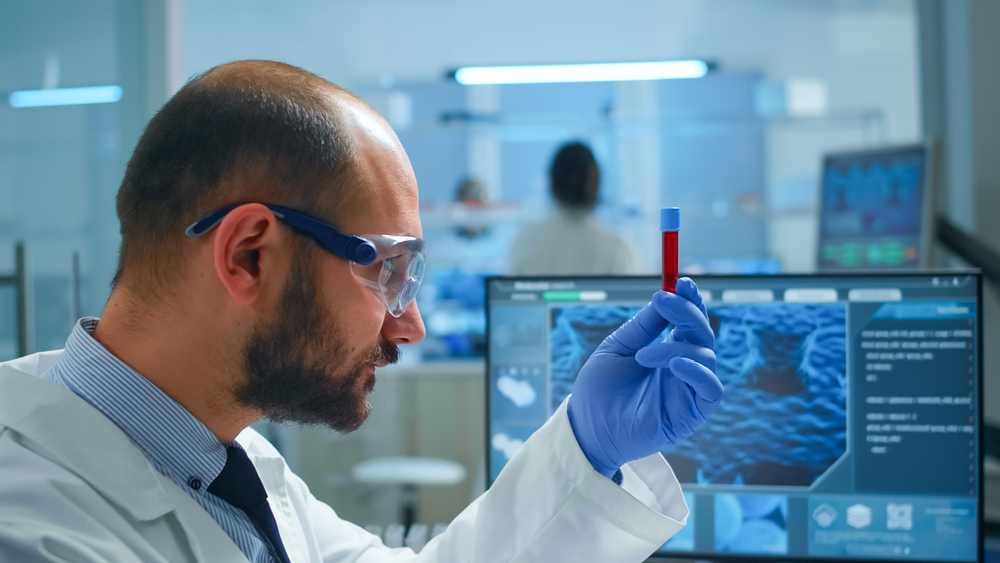 Viorolog,Researcher,Examining,Blood,Sample,From,Test,Tube,Working,In