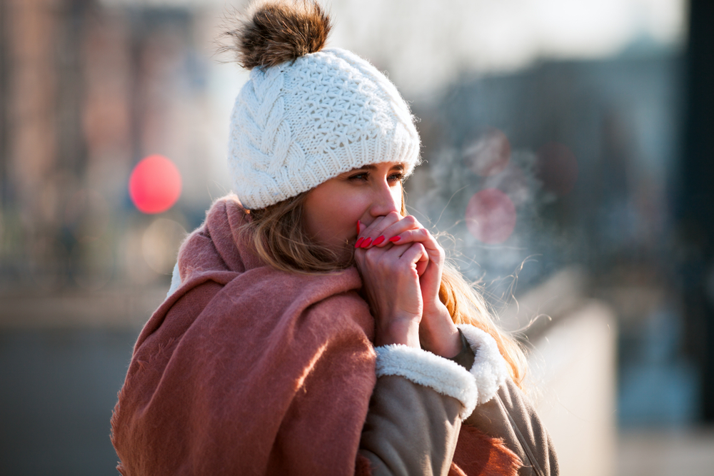 Woman,Breathing,On,Her,Hands,To,Keep,Them,Warm,At