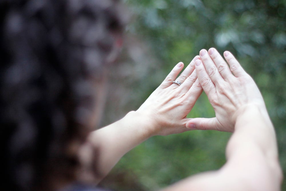 Female,Forming,A,Triangle,With,Hands